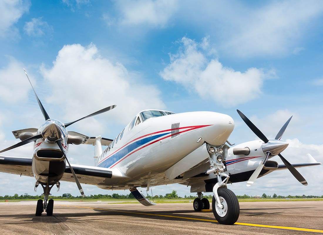 Aviation Insurance - Small Plane Waiting on the Runway with a Big Blue Sky